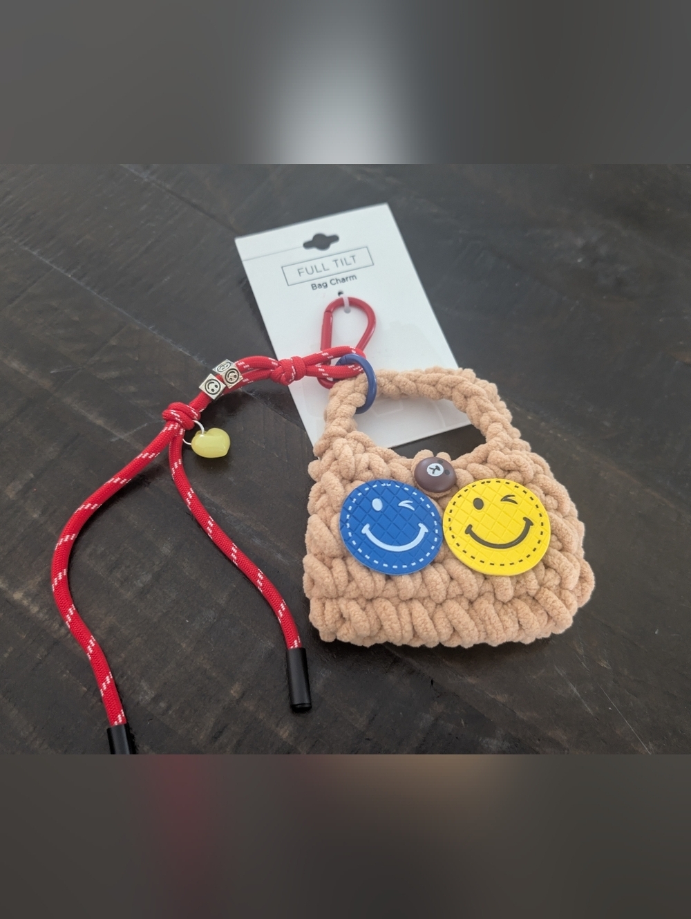 Full Tilt Beige Crochet Kids Bag Charm with Blue & Yellow Smiley Faces